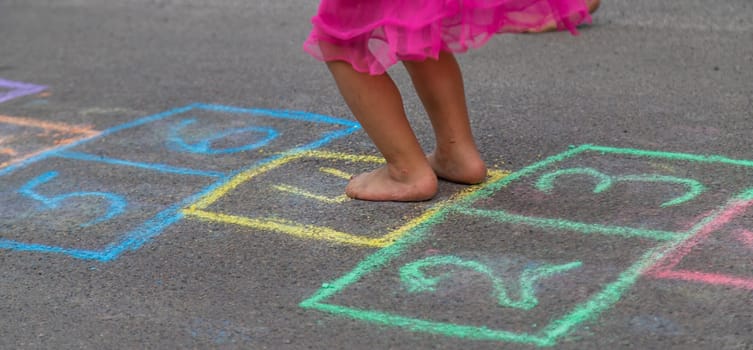 Children play hopscotch on the street. Selective focus. Nature.