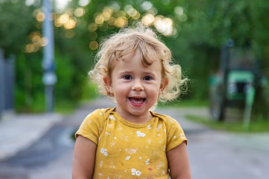 Cheerful child on the street portrait. Selective focus. Kid.