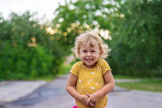 Cheerful child on the street portrait. Selective focus. Kid.