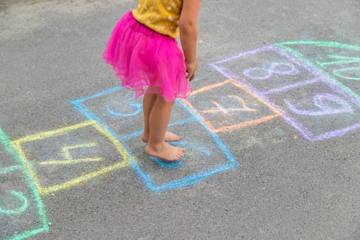 Children play hopscotch on the street. Selective focus. Nature.