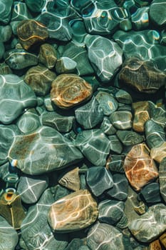 View from above of the crystal clear water along the shoreline with rocky seabed.