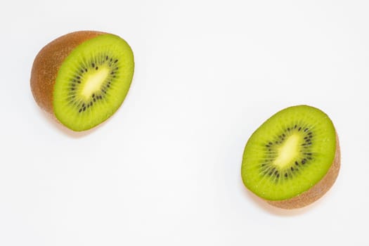 Close up from a kiwi cut in half on a white background.