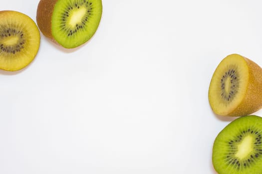 Mix of green and yellow kiwi's cut in half, on a white background.