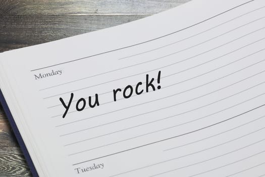 A You rock reminder message in an open diary