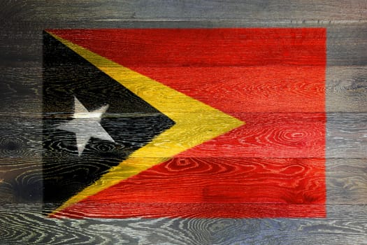 An East Timor flag on rustic old wood surface background