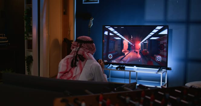 Middle Eastern gamer feeling gutted after losing singleplayer action videogame level, being outsmarted by enemies. Muslim man at home frustrated after seeing game over screen