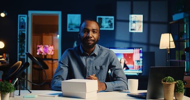 Content creator filming review of newly released smartphone, unpacking it and presenting specs to audience. Influencer showing phone recommendation to subscribers doing research before buying