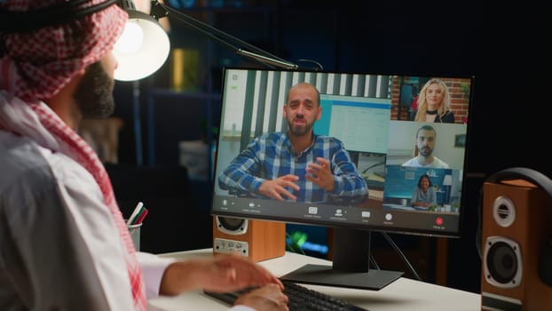 Arabic team leader holding online video conference meeting with remotely working subalterns, checking on task progress. Middle Eastern business executive discussing with workers during video call