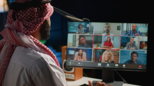 Arab man paying attention in elearning seminar teleconference. Middle Eastern student in online videocall with tutor and other colleagues, listening to lesson and participating