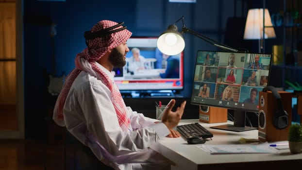 Muslim team leader holding online video conference meeting with remotely working subalterns, checking on task progress. Middle Eastern business executive discussing with employees during video call