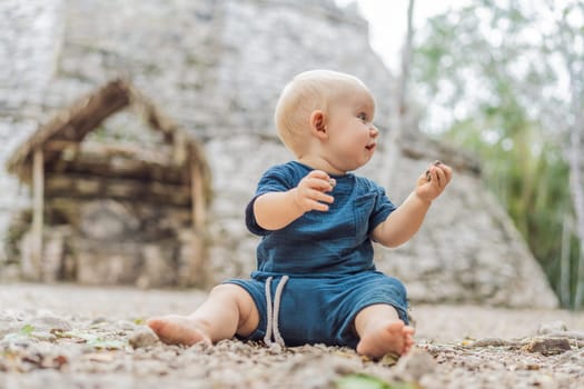 Baby tourist at Coba, Mexico. Ancient mayan city in Mexico. Coba is an archaeological area and a famous landmark of Yucatan Peninsula. Cloudy sky over a pyramid in Mexico.