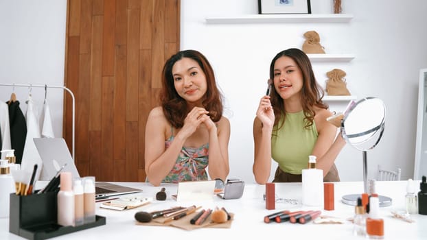 Two influencer partner shoot live streaming vlog video review makeup social media or blog. Happy young girl with vivancy cosmetics studio lighting for marketing recording session broadcasting online.