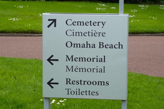 Directional sign at American cemetery at Normandy area. WWII memorial. High quality photo