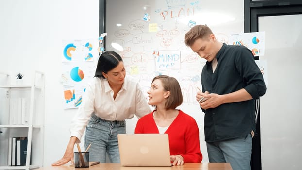 Professional business team working together in start up project at business meeting in front of glass board with mind map while colleague brainstorming and discussing about strategy. Immaculate.