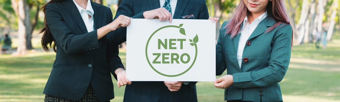 Group of business people stand united, holding eco-friendly idea and concept for environmental awareness campaign by business corporate to embrace net zero emission and environmental friendly. Gyre