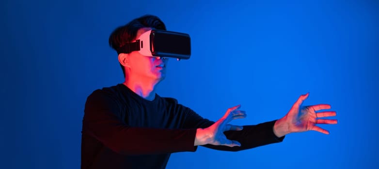 Asian athlete with VR holding a basketball player exploring virtual space on neon portrait sports training connecting digital futuristic hologram technology metaverse world playing court. Contrivance.