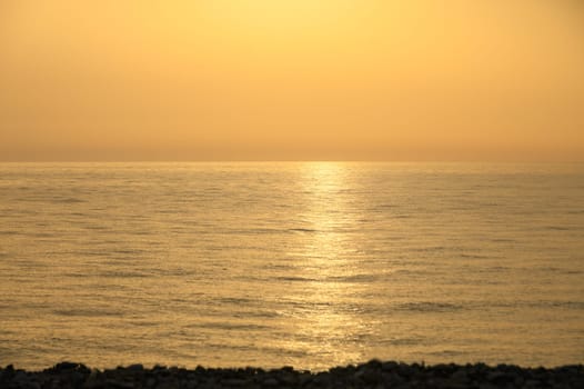 Golden hour shot of the sun setting over the Mediterranean Sea