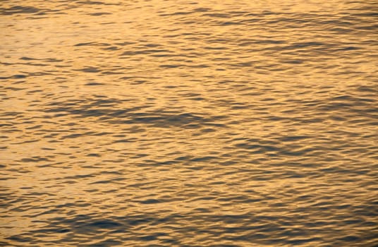 waves of the Mediterranean sea in the rays of sunset