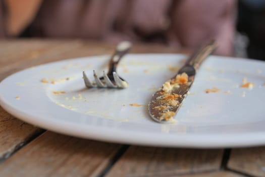 An empty dirty plate with a fork..