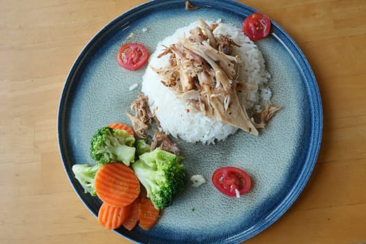 Boiled chicken, steamed rice, pink plate. High quality photo