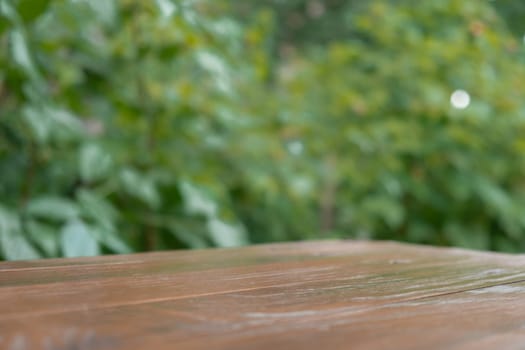 Wooden table at alcove in garden outdoor. Background of greenery. Template mock up podium for advertisement. Connection with nature