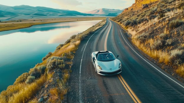 An super car drives along the road along the water reservoir ridge