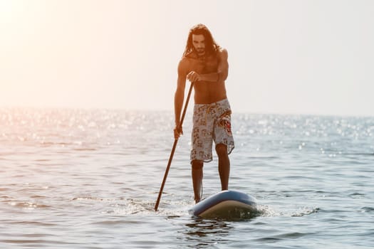 Man Sea Sup. Strong athletic man learns to paddle sup standing on board in open sea ocean on sunny day. Summer holiday vacation and travel concept. Aerial view. Slow motion.