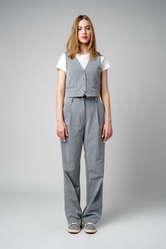 Young Woman Wearing Gray Suit and White Shirt on gray background