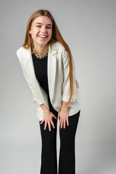 Woman in Black Top and White Jacket Posing in Studio close up