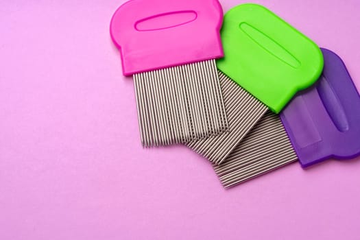 Three combs for removing lice and nits on lilac background close up