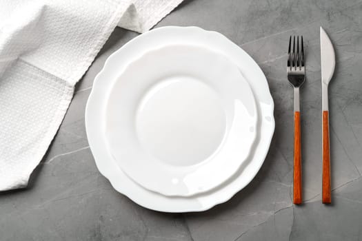 Elegant table setting on grey marble background, flat lay