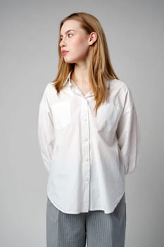 Young Woman in White Shirt Posing for Picture in studio