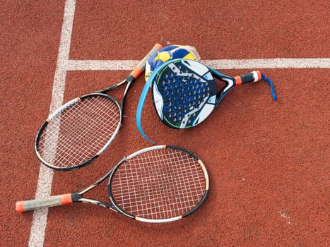 The broken rackets for playing tennis are hanging on the wall of a sports tennis club. . High quality photo