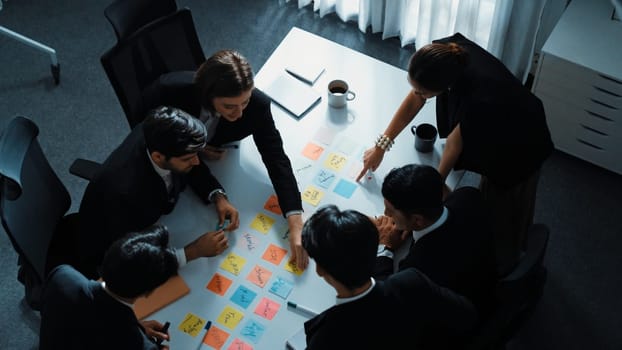 Top view of smart executive manager discuss and choose marketing idea from sticky notes. Group of business team talking and brainstorming strategy while making decision and choose plan. Directorate.