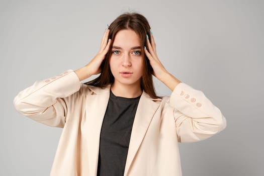 Young Woman Showing Surprise Expression on Gray Background close up