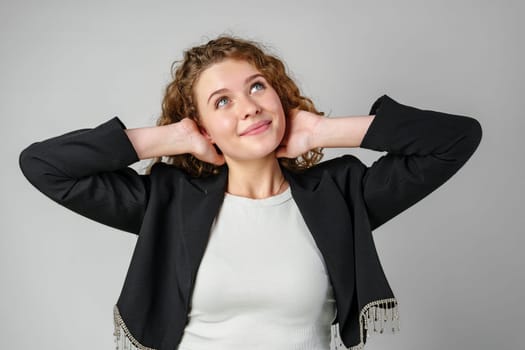 Young Woman With Curly Hair Portrait against gray background in studio