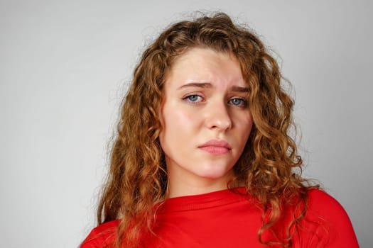 Young Woman With Curly Hair Expressing Concern Upset Sad