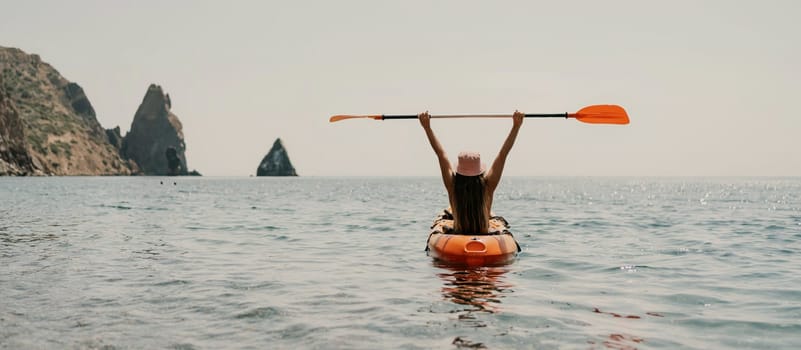 Kayak sea woman. Happy attractive woman with long hair in red swimsuit, swimming on kayak. Summer holiday vacation and travel concept