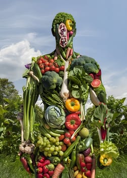 A unique piece of art, the statue of a man made entirely of plantbased foods such as fruits and vegetables, showcasing the beauty and diversity of natural foods and the importance of agriculture