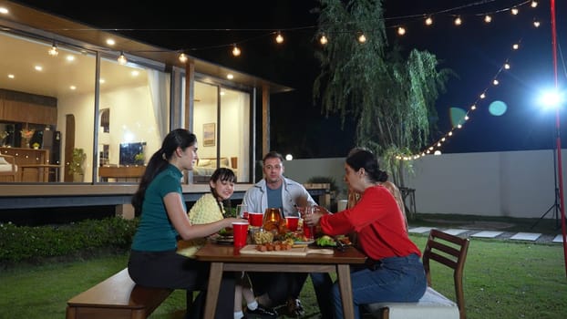 Family gather celebrate holiday. Parents, grandparents and girl together to talk and have dinner party food. Outdoor activity for spending time with multigeneration cross generation gap. Divergence.