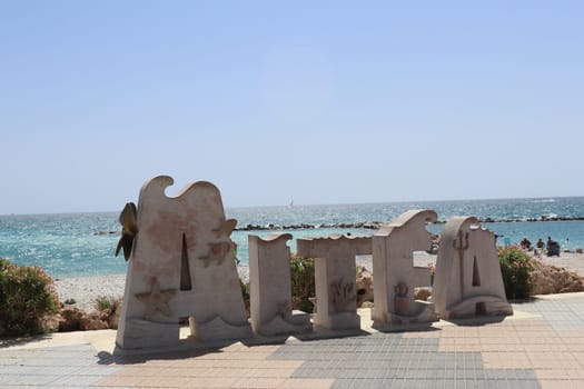 Stone block of the seafront promenade with the name of a Spanish coastal town. In the letters it says in Spanish Altea . Alicante. Spain