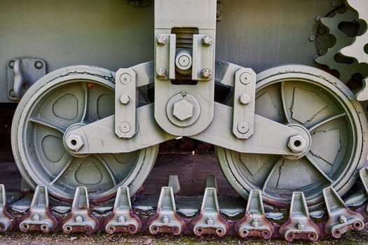 Close-up of a tank's track and wheels in Warsaw, Indiana, showcasing robust military engineering.