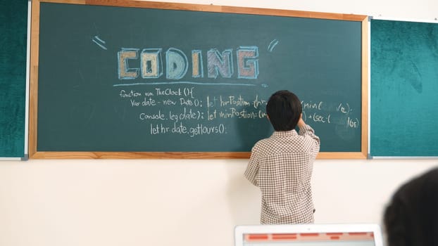 Girl writing engineering prompt by using AI software or programing system to generate AI on table with electronic main board at stem class while smart boy writing software development plan. Pedagogy.