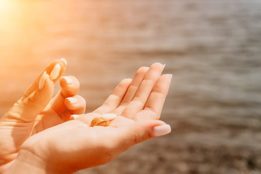 Woman eating milky almond nuts. A young caucasian woman choping fresh green almond after morning fitness yoga near sea. Only hands are visibly. Healthy vegan food. Slow motion. Close up