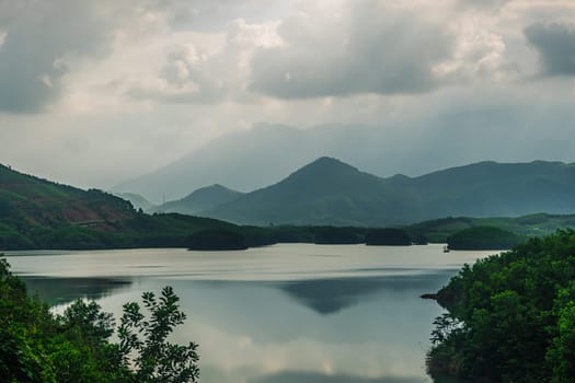 Magic summer scenery Forested mountains Lake Clouds Sun beams Soul healing Meditation Inspiration.