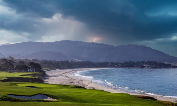 oceanside golf course with bunker,  ocean and clouds