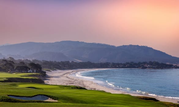 oceanside golf course with bunker,  ocean and clouds