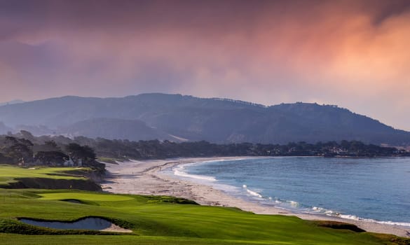 oceanside golf course with bunker,  ocean and clouds