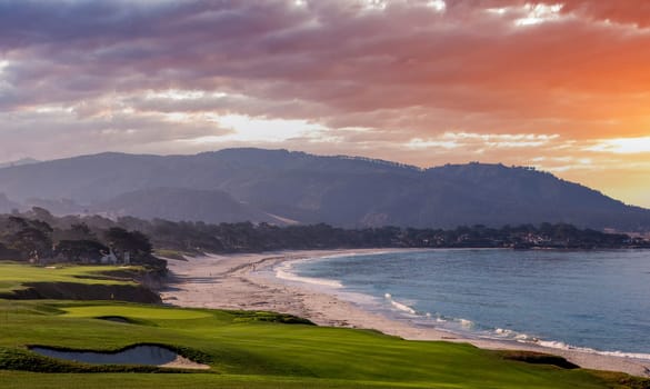 oceanside golf course with bunker,  ocean and clouds