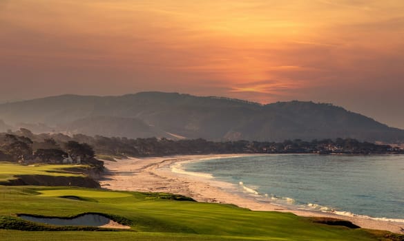 oceanside golf course with bunker,  ocean and clouds